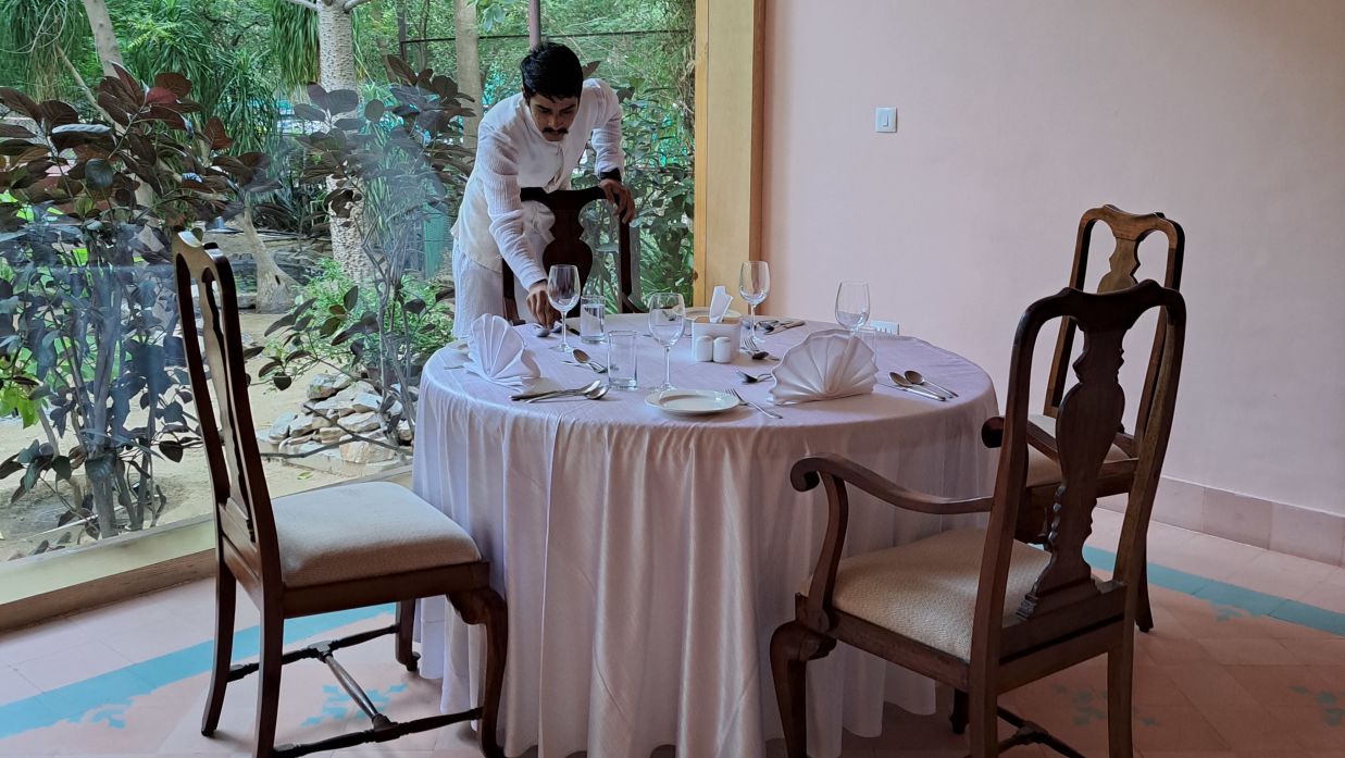 A staff setting the table at Goose the restaurant - Clarks Amer Jaipur