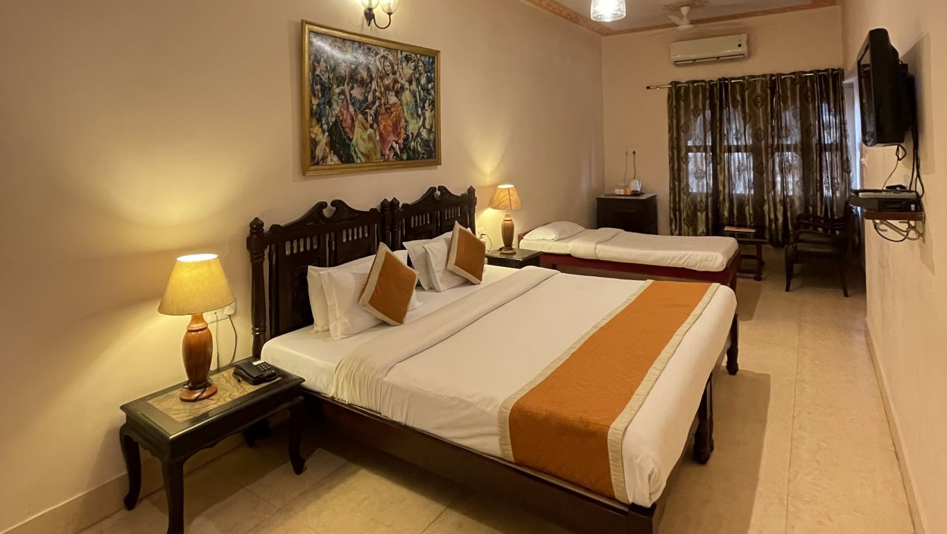 A double and a single bed in the Deluxe triple room at Suryaa Villa Jaipur