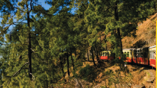 A train on a railway track in the hills