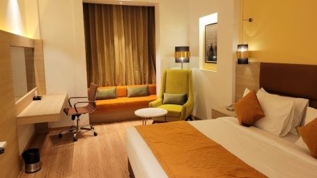 room with a king size bed and wooden flooring at best western vrindavan