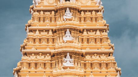 facade of a temple in Tirupati with intricate carvings and dark skies in the background