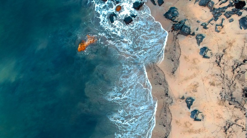 aerial view of beach with blue ocean