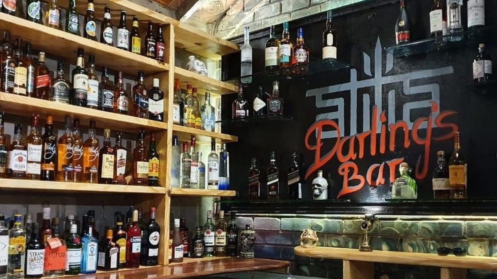 Bar counter with drinks kept on shelves