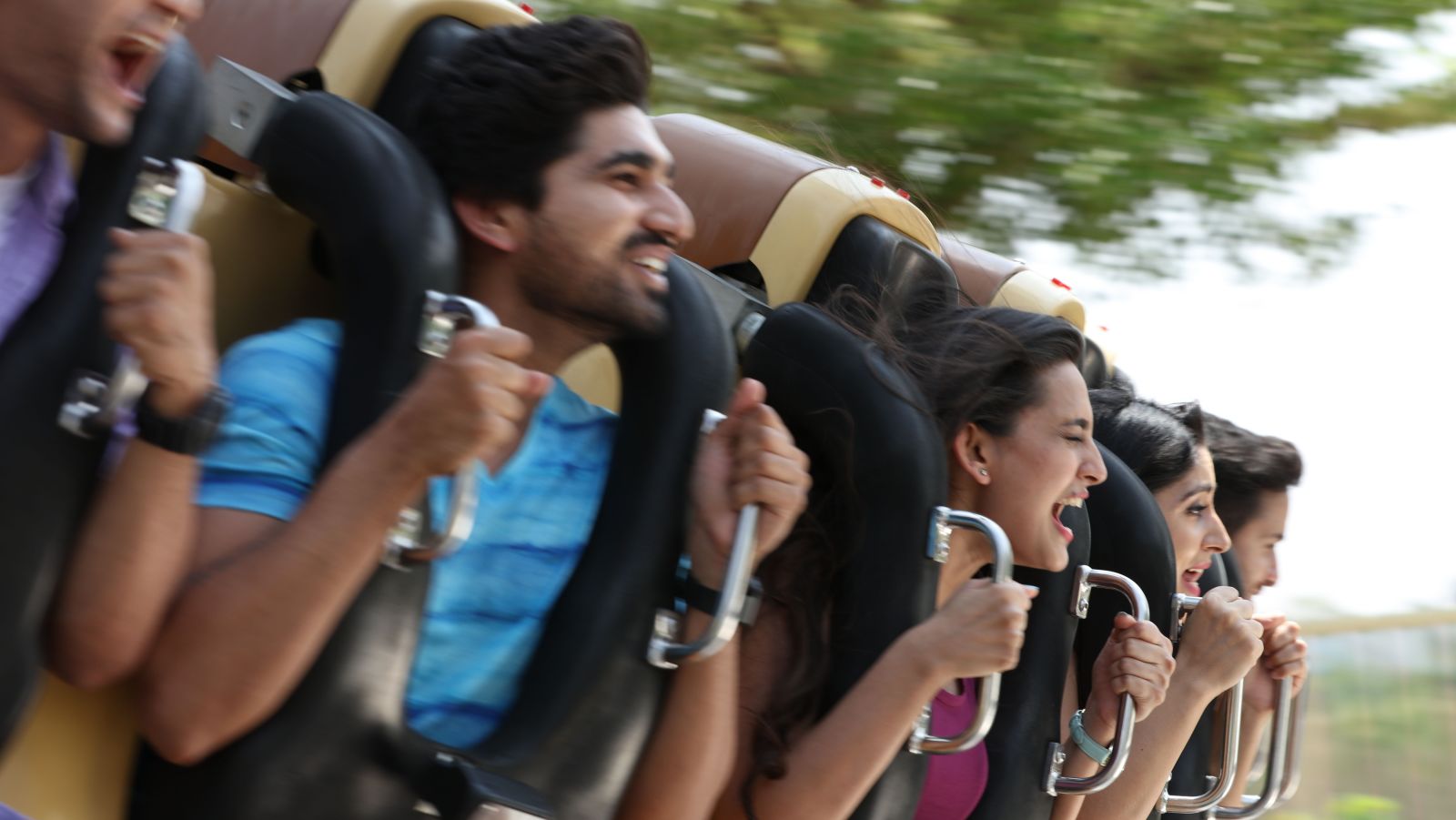 People screaming as they hold on to their safety harness