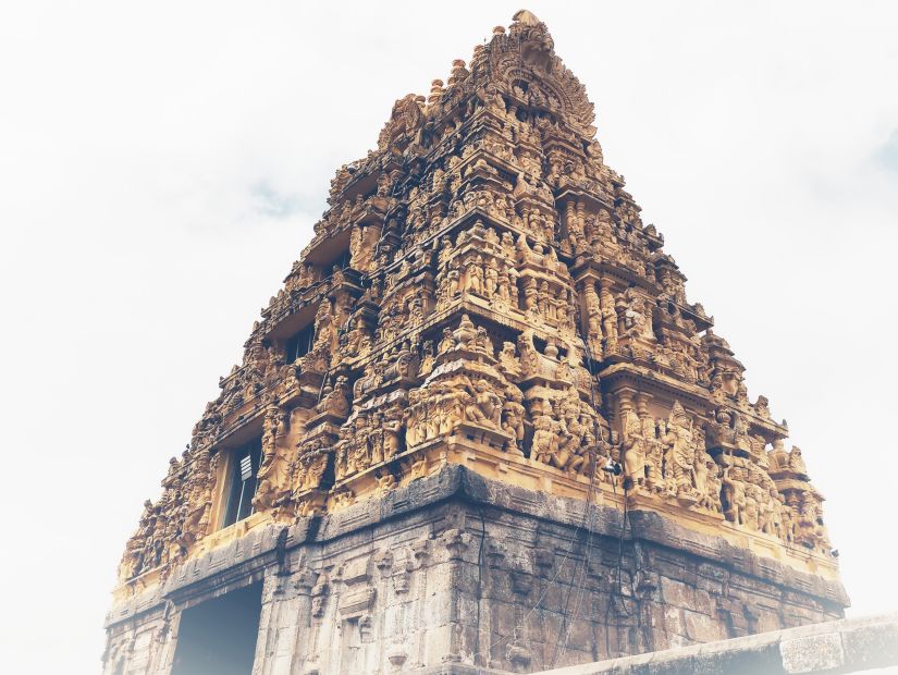 an old temple facade with intricate carvings on the roof of idols