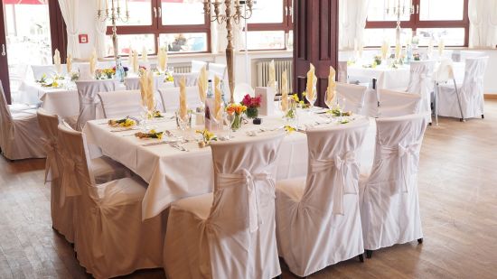 View of Ballroom with tables covered in white linens and several chairs - Mastiff Grand- The Sia Palace Suites and Banquets, Khopoli