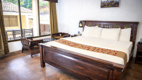 Adamo The Village - the balcony beside the king size bed offered at the Super Deluxe rooms in Matheran