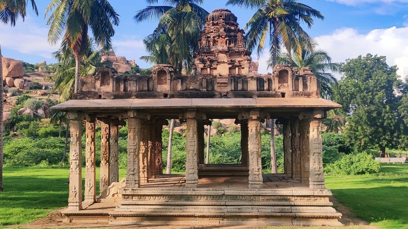 an image of an ancient Indian temple surrounded by trees during daytime