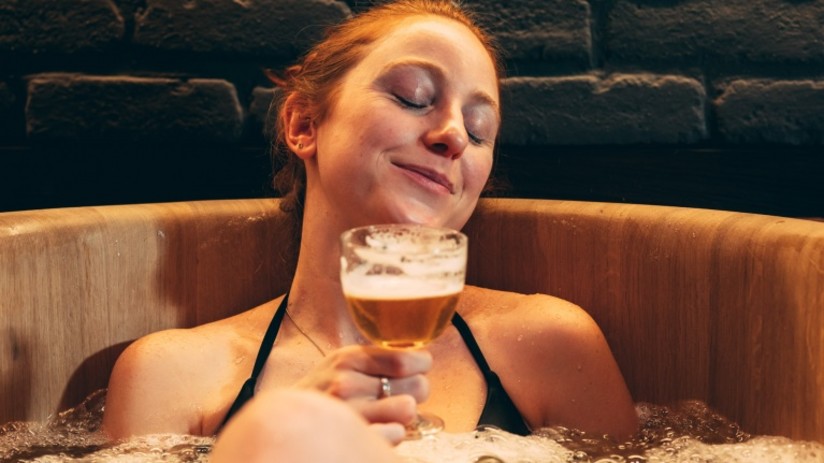 Woman enjoying a beer bath at our wellness resort in Goa