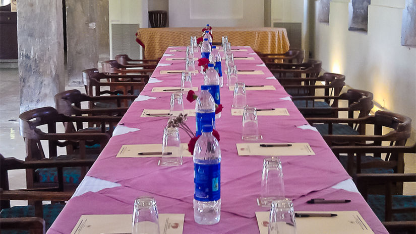 Deo Bagh - 17th Century, Gwalior - a long dining table covered in pink cloth and chairs on either side