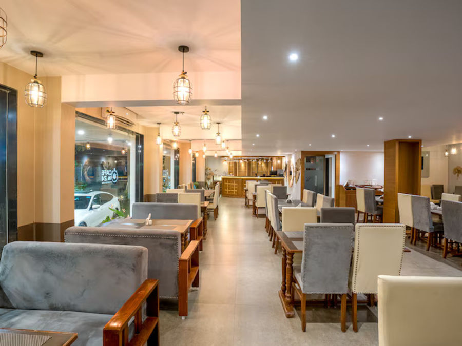 alt-text Image of M Cafe with sofa and tables at Vagator Downtown, Goa