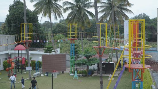 Zipline and kids' playground area with some children spotten far away