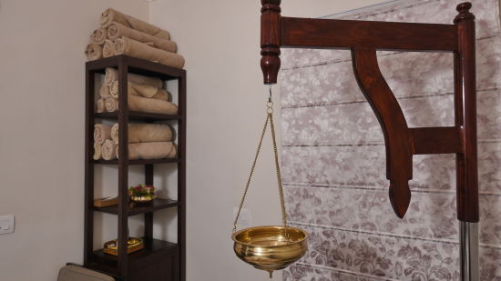 a bowl hanging by a wooden pillar