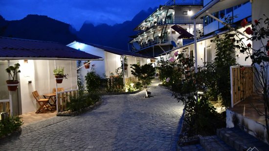 a well-lit exterior view of The Tattva Boutique Resort, Joshimath at night