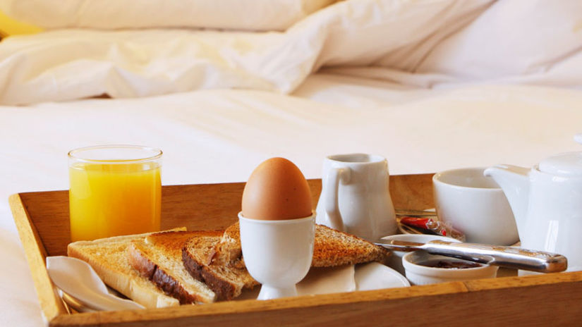 a tray with breakfast served on bed