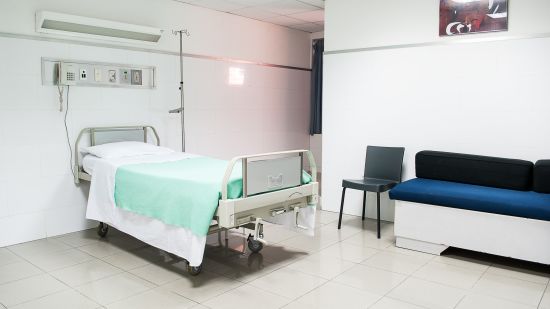 A hospital bed with seats nearby