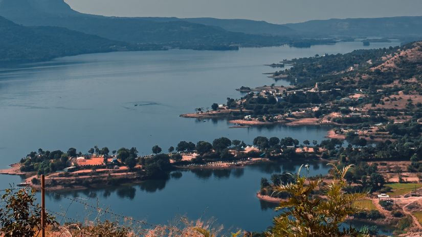 an image of Pawna lake shot from a angle that highlights the hills surrounding the lake