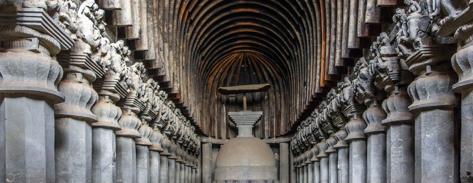 A very long room with many statues on the walls.