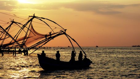 fishermen fishing using nets during sunsetz