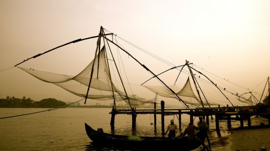 fishermen fishing using nets during sunset 