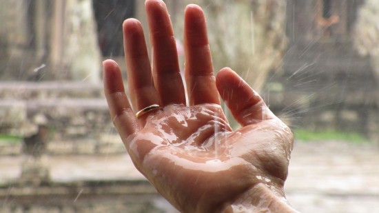 rain falling on a person's hand