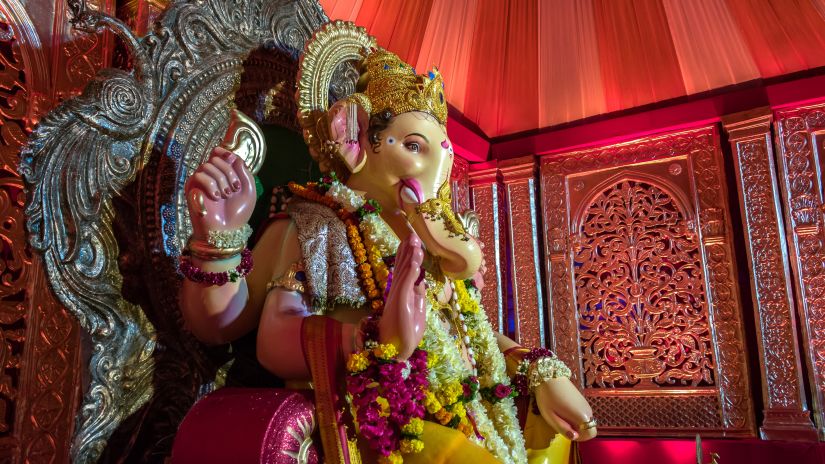 idol of lord ganesha sitting on a throne