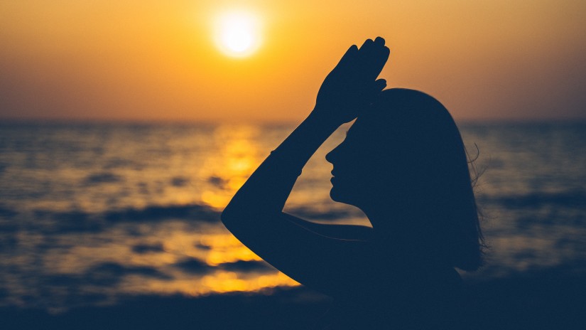 a woman  doing beachside yoga in Goa