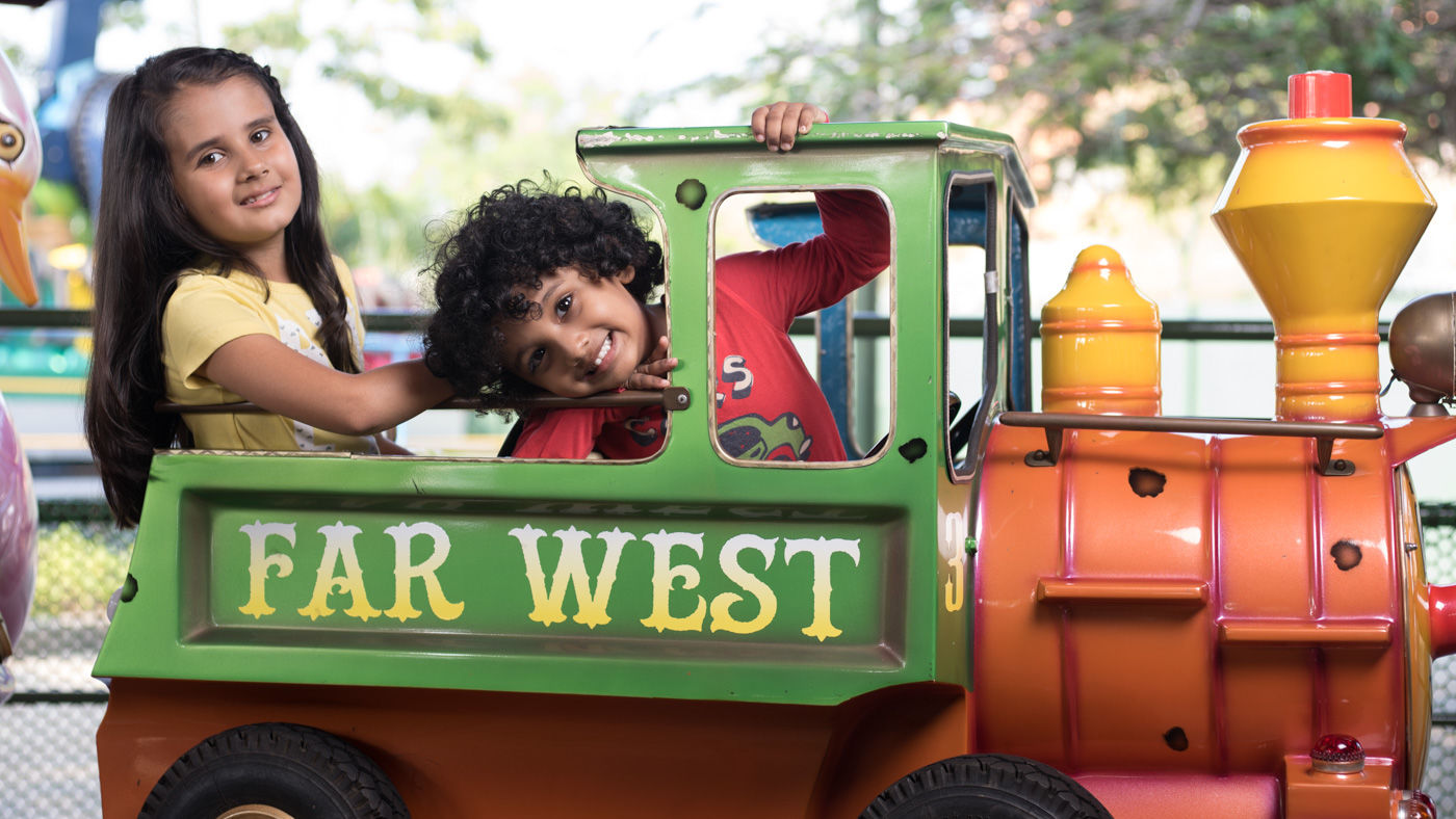 Kids seated atop a toy train