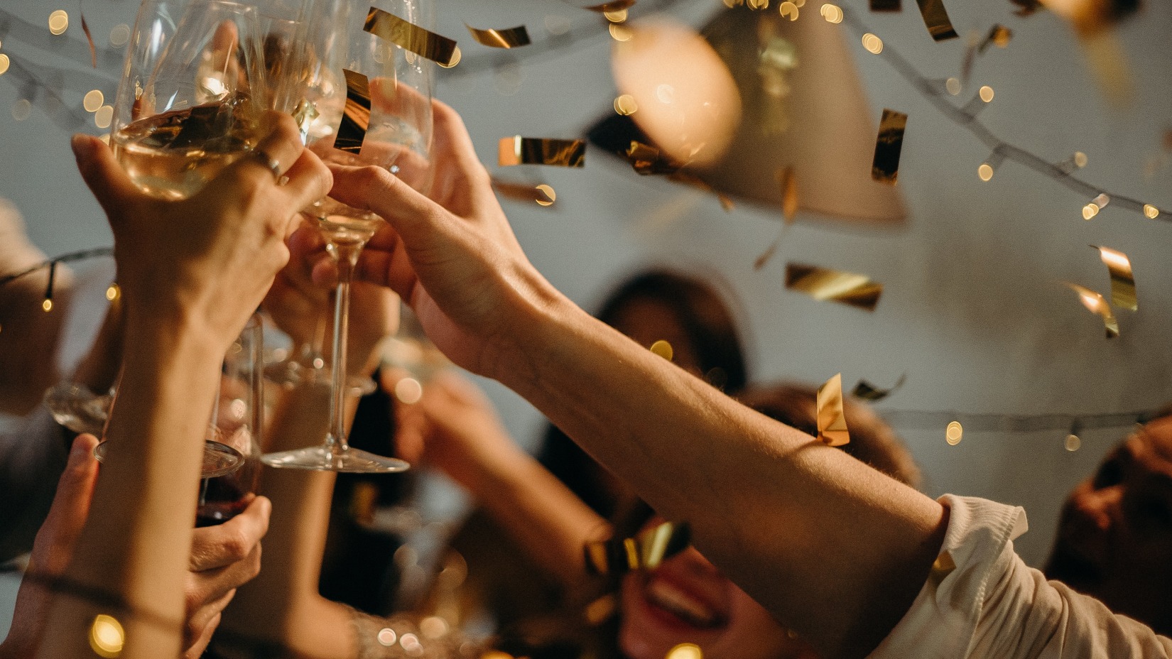 a group of people raising a toast with glasses in the air