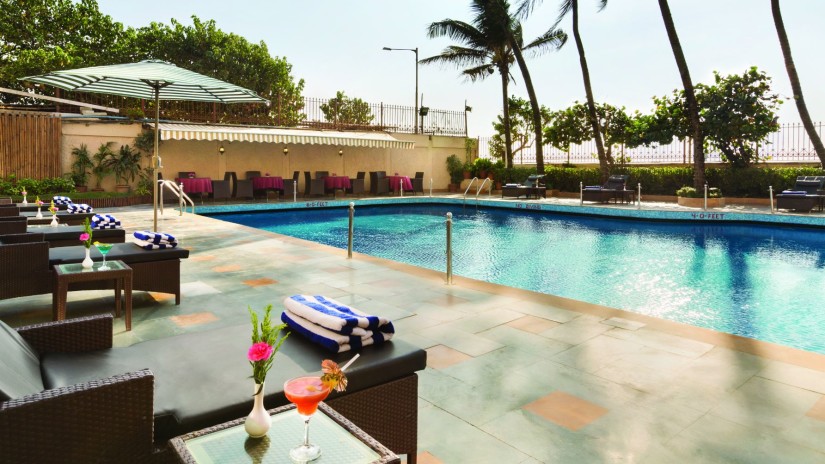 poolside patio at Ramada Plaza Palm Grove 34