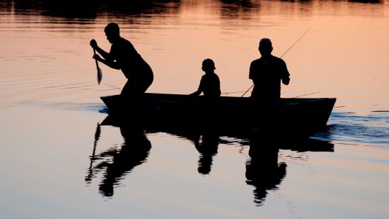 fishermen fishing using nets during sunset 