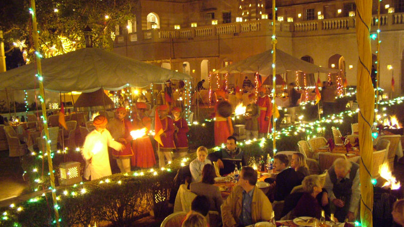 Gala Dinner at Gulab Bagh with guests being entertained by performers  - Hotel Castle Mandawa, Jhunjunu