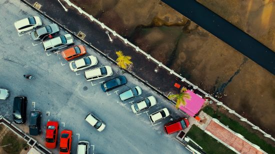 top view of a vehicle parking with cars parked 