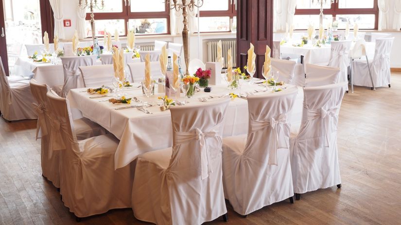 View of Ballroom with tables covered in white linens and several chairs - Mastiff Grand- The Sia Palace Suites and Banquets, Khopoli