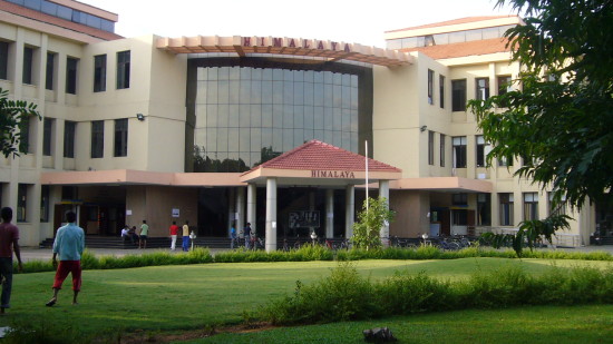 College building with lawn and people on it