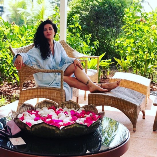 Woman in blue dress lounging on a chair