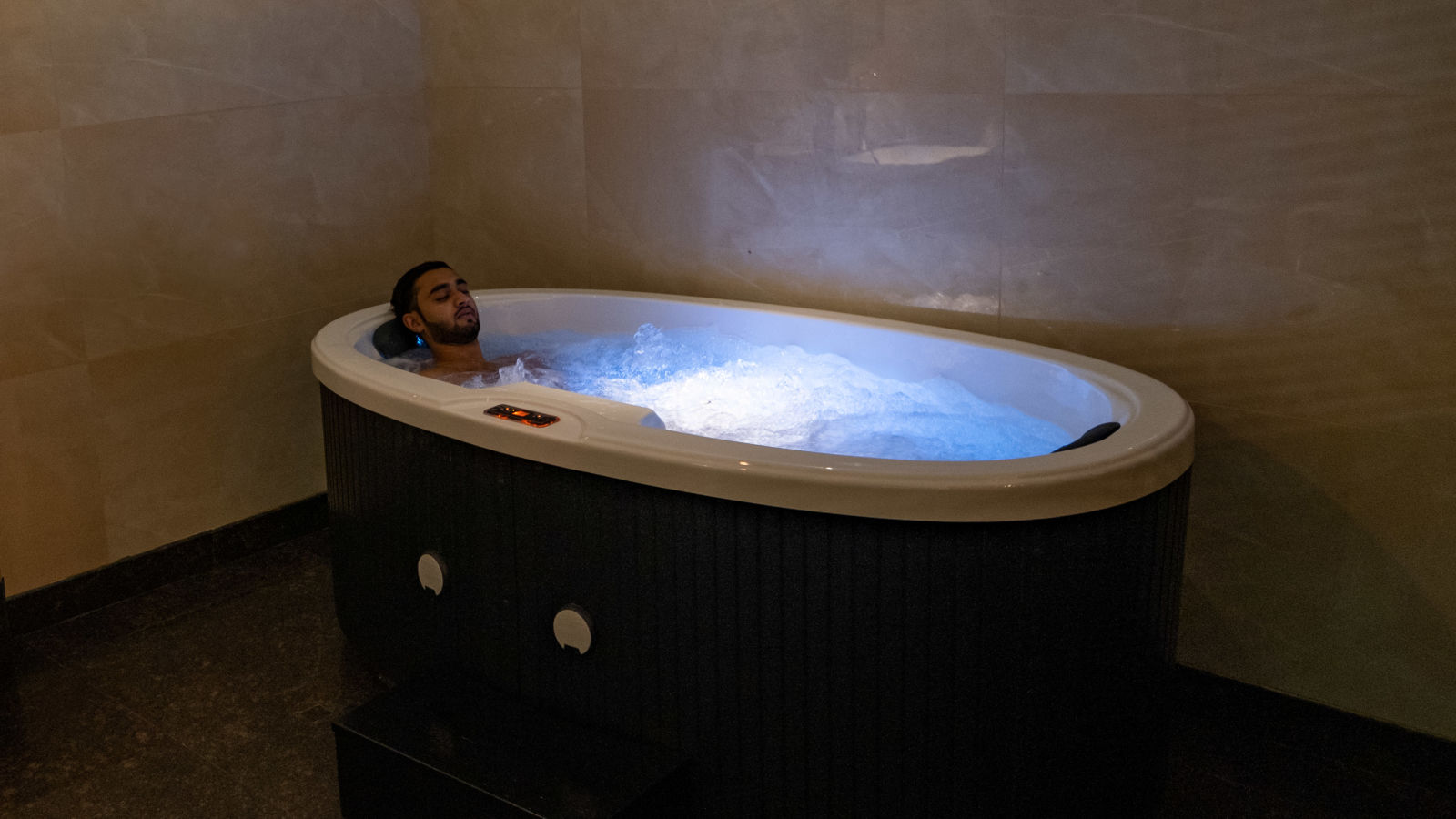 a person soaking in a Jacuzzi