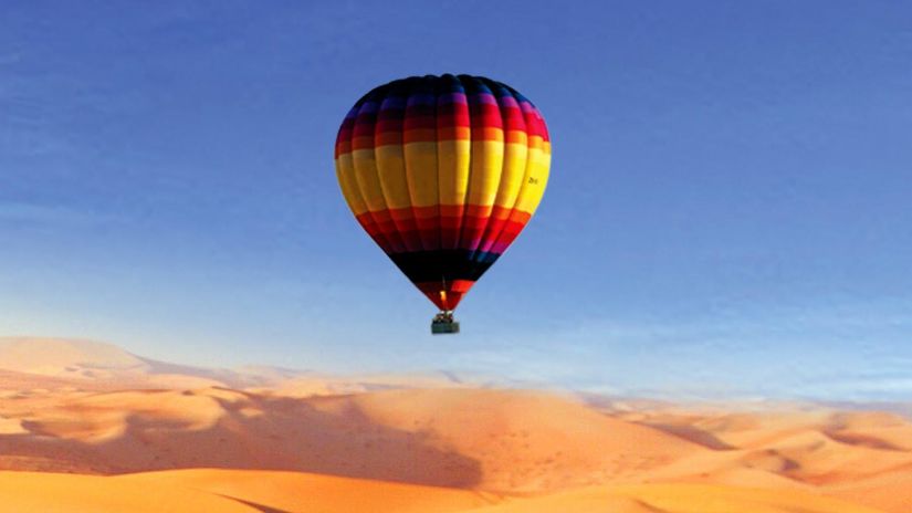 A hot air balloon gliding over the desert in Pushkar 