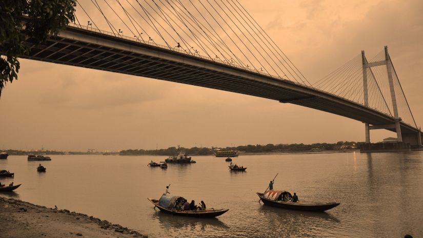 view of the howrah bridge and river hooghly running under it