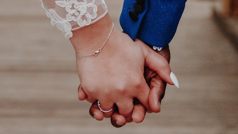 bride and groom holding hands