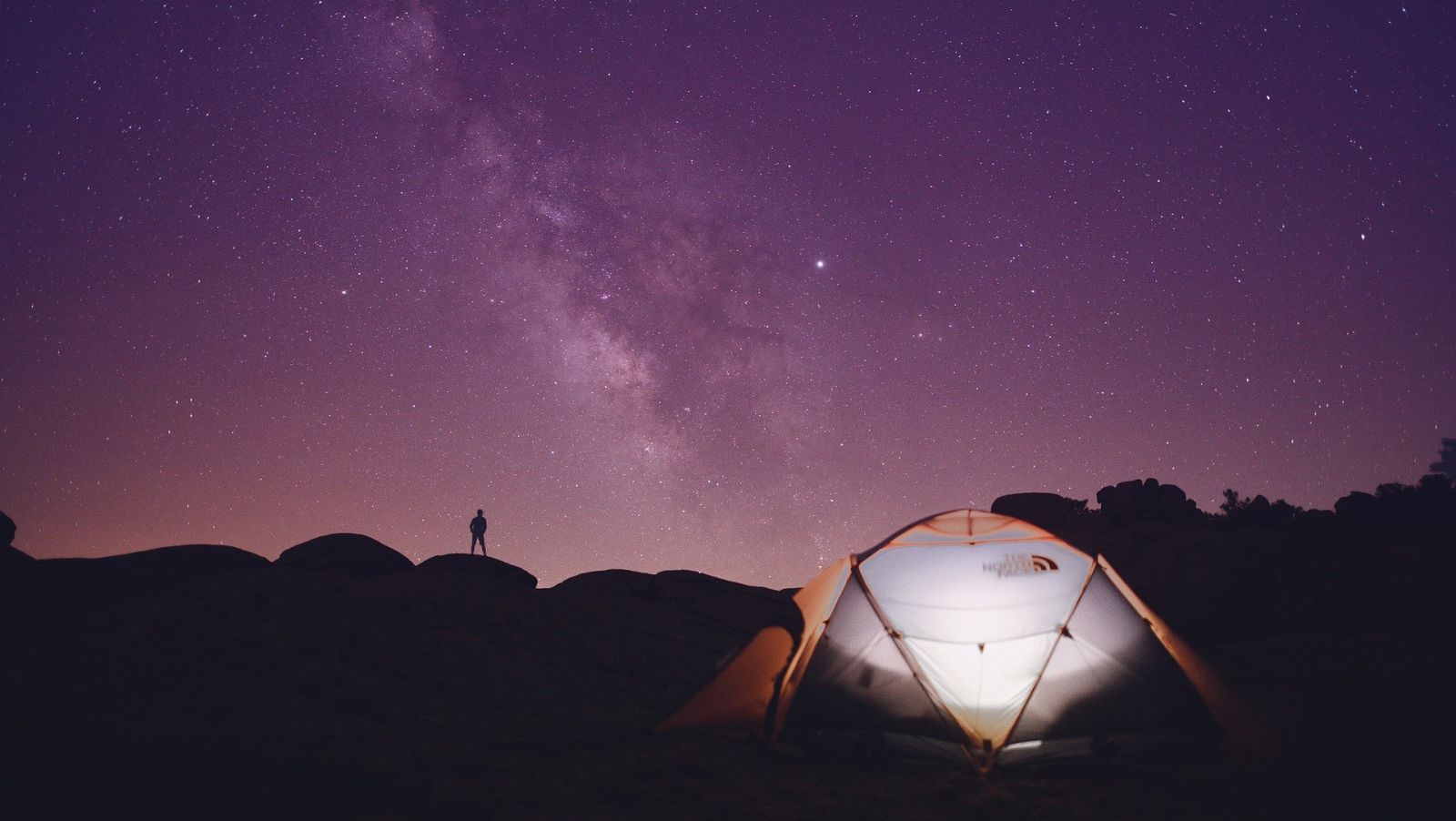 Tent under purple night sky