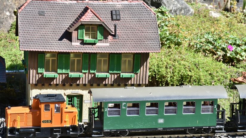 A toy train ride in front of a cottage