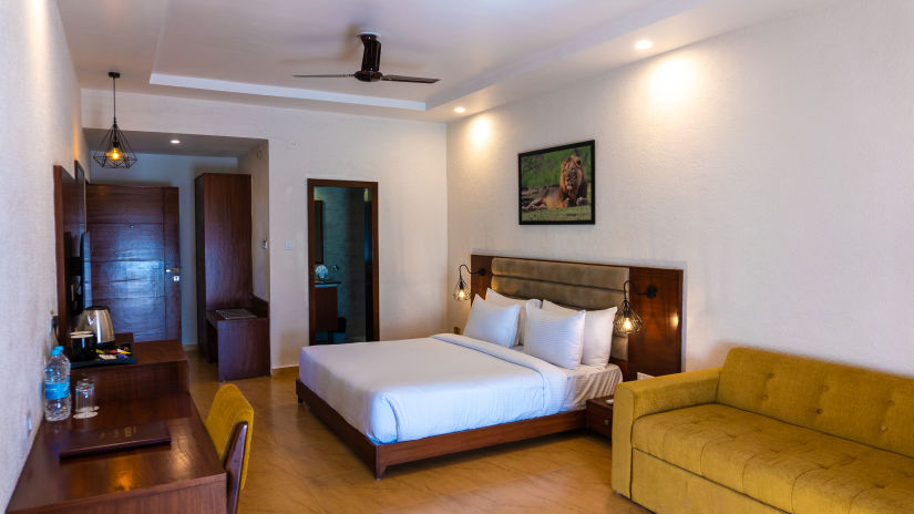 bedroom with white bed covers and other various other amenities at Jagira Ananta Elite 10