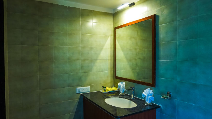 modern bathroom with dim lighting and modern amenities at Jagira Ananta Elite