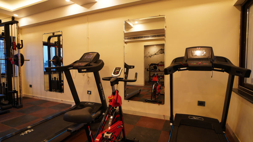 treadmills with a cycle and mirrors inside the fitness centre - Shanti Seaview Resort & Spa