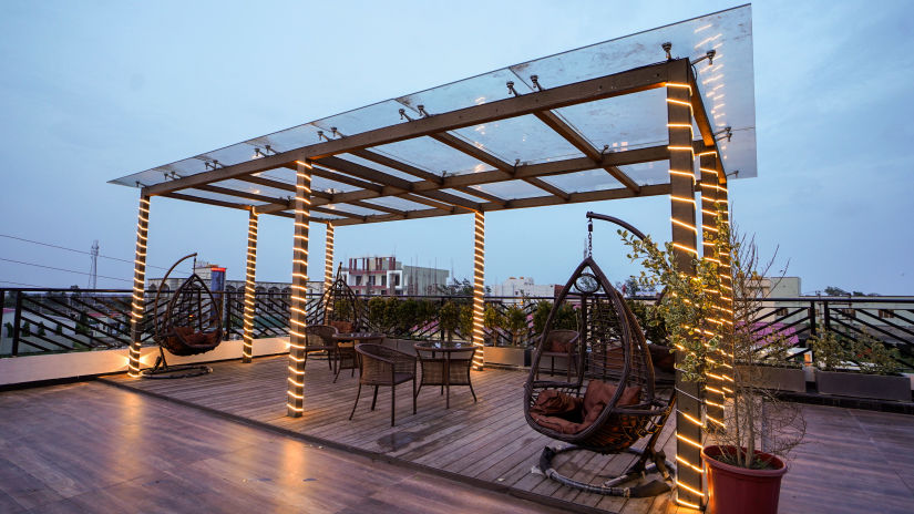 Different types of seats on the terrace with a see through roof - Shanti Seaview Resort & Spa