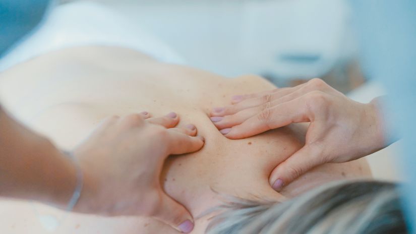 a person getting back pressed by a masseuse