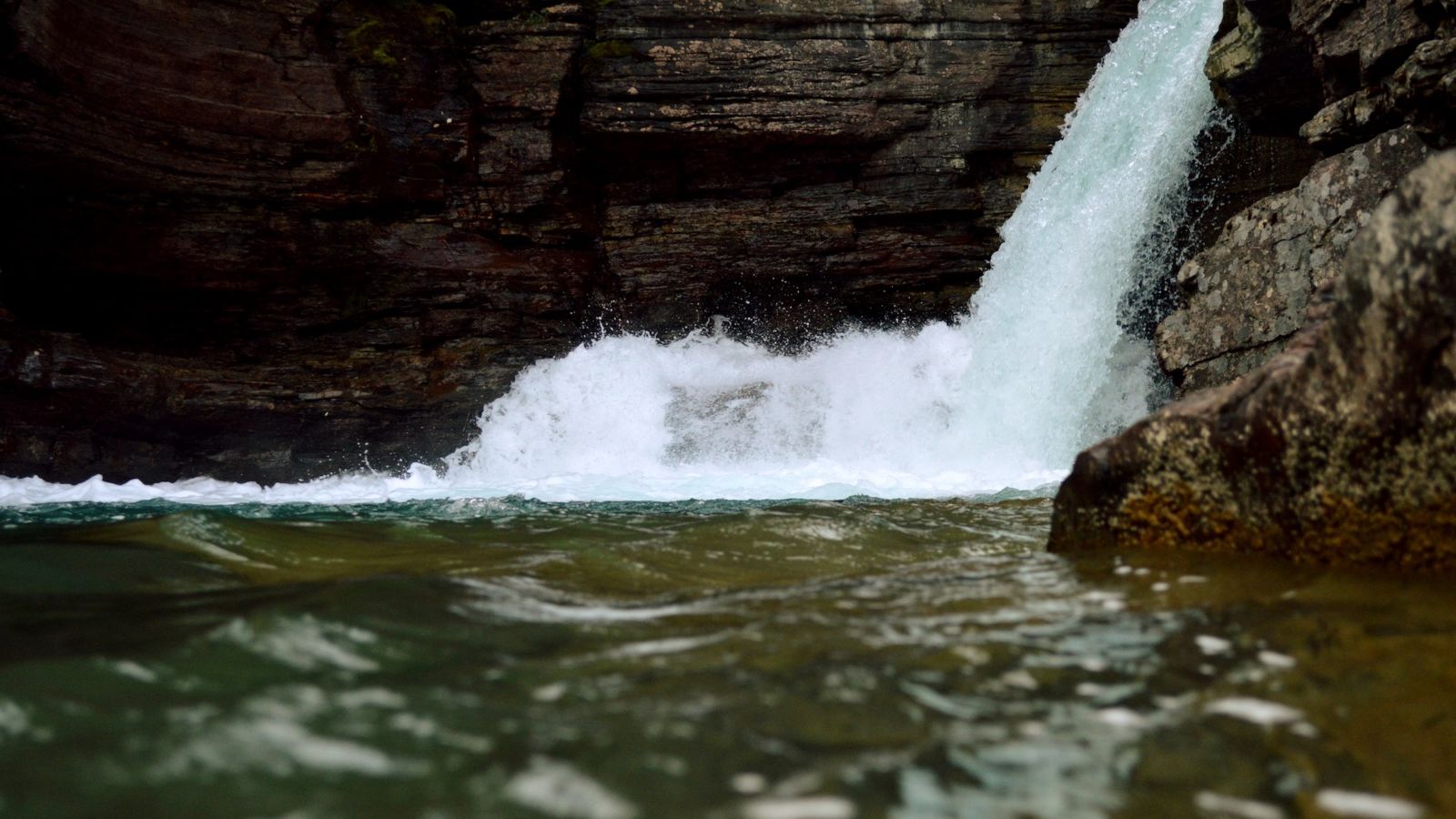 rapid flow of water at a waterfall