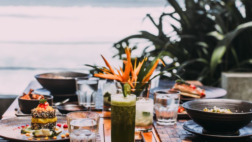 food served on a table beside a water body