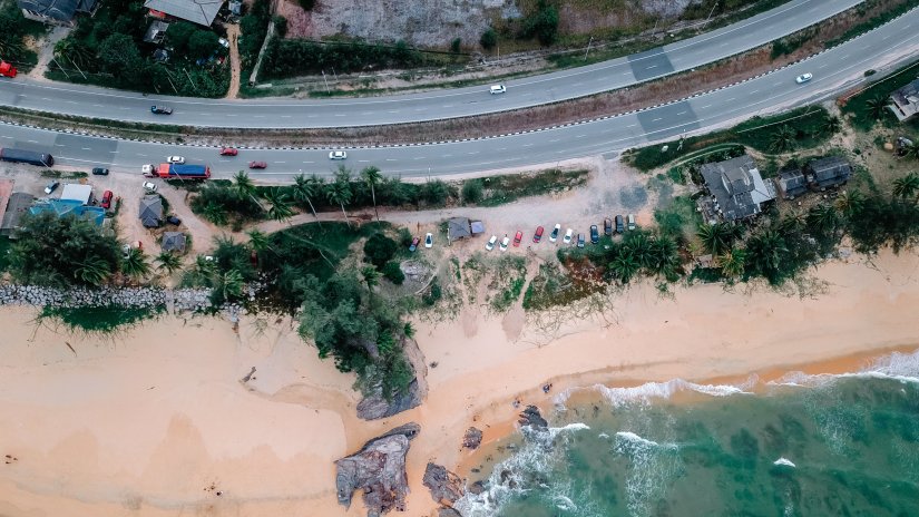 Top view of road where it is closest to a beach